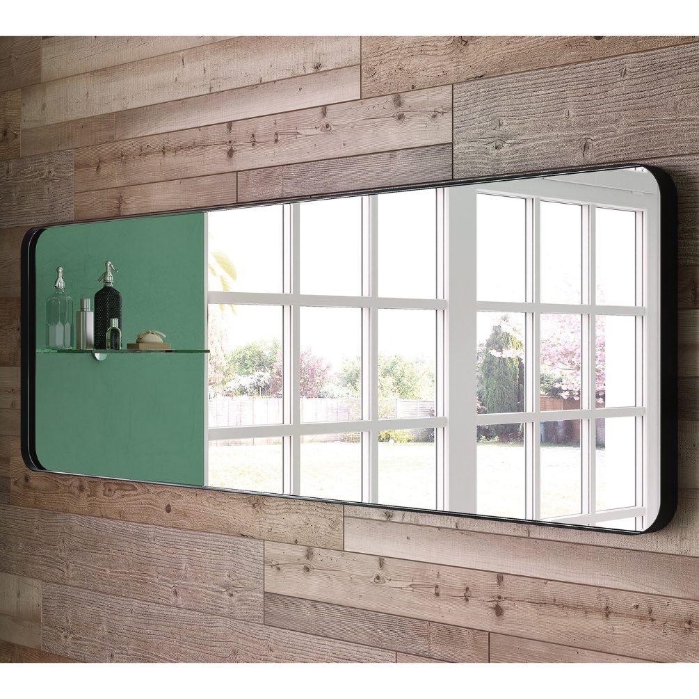 Product Lifestyle image of the Origins Living City Rectangular 500mm x 1500mm Black Mirror mounted landscape on a wooden wall, reflecting an outside view. B375615